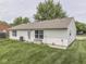 View of the backyard showcasing the lawn and white siding of the house at 2756 Branigin Creek Blvd, Franklin, IN 46131