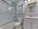 Bathroom featuring a tub with glass doors, white vanity and a medicine cabinet at 2756 Branigin Creek Blvd, Franklin, IN 46131