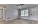 Bright, spacious living room featuring modern flooring, a ceiling fan and access to other rooms at 2756 Branigin Creek Blvd, Franklin, IN 46131