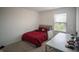 Cozy bedroom featuring a red bed, white walls, and a desk with a window view at 2916 W Bargello Ln, Monrovia, IN 46157