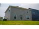 Back exterior of house featuring windows, door, gray siding and green lawn at 2916 W Bargello Ln, Monrovia, IN 46157