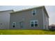 The exterior of the house featuring gray siding, lawn, and windows at 2916 W Bargello Ln, Monrovia, IN 46157