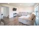Comfortable living room featuring a plush sectional sofa, modern lighting, and laminate flooring at 2916 W Bargello Ln, Monrovia, IN 46157