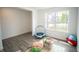 Inviting living room featuring a large window for natural light, laminate floors and toddler trampoline at 2916 W Bargello Ln, Monrovia, IN 46157