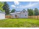 Picture of a spacious backyard featuring a wooden fence, deck, and lush lawn at 300 N Church St, Arcadia, IN 46030