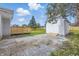 View of a well-maintained backyard with a deck, shed, and gravel parking area at 300 N Church St, Arcadia, IN 46030