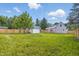 Expansive backyard with lush green grass, shed, and wooden fence surrounding the property at 300 N Church St, Arcadia, IN 46030