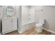 Clean bathroom featuring modern vanity with a round mirror and a shower and bathtub combo at 300 N Church St, Arcadia, IN 46030