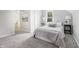 Bright bedroom with neutral tones, soft carpet, and a view to a conveniently located bathroom at 300 N Church St, Arcadia, IN 46030