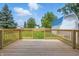 Wooden deck with railings overlooking a spacious, green backyard with a blue shed at 300 N Church St, Arcadia, IN 46030