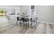 Dining area with black chairs, a white table, and a view of the kitchen; showcases an open layout at 300 N Church St, Arcadia, IN 46030