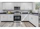 Kitchen with stainless steel appliances, white cabinets, dark countertops, and lots of natural light at 300 N Church St, Arcadia, IN 46030