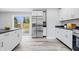 Modern kitchen featuring stainless steel appliances, white cabinets, and an island with bar stools at 300 N Church St, Arcadia, IN 46030