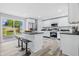 Modern kitchen with stainless steel appliances, a breakfast bar, and a view of the deck at 300 N Church St, Arcadia, IN 46030