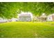 Spacious backyard features a lush lawn, mature tree, and view of the home at 3004 Sheridan St, Anderson, IN 46016