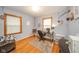 Bright bedroom featuring hardwood floors, two windows, neutral paint, and a dedicated workspace at 3004 Sheridan St, Anderson, IN 46016