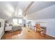 Attic bedroom featuring hardwood floors, a bed, desk, TV, and unique wooden beam at 3004 Sheridan St, Anderson, IN 46016