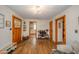 Open concept living room with hardwood floors, decorative lighting, and seamless flow to adjacent rooms at 3004 Sheridan St, Anderson, IN 46016