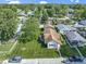 An aerial view of the home, highlighting the landscaping, lawn, and surrounding neighborhood at 310 W Jackson St, Alexandria, IN 46001