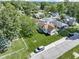 A high angle aerial view showcasing the home, lawn, and surrounding neighborhood at 310 W Jackson St, Alexandria, IN 46001