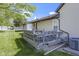 Backyard view of deck and back of home with vinyl siding and small yard at 310 W Jackson St, Alexandria, IN 46001