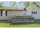 Backyard view of deck and back of home with vinyl siding and small yard at 310 W Jackson St, Alexandria, IN 46001