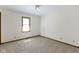 A neutral bedroom with light colored walls and carpet and window with blinds at 310 W Jackson St, Alexandria, IN 46001