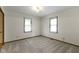 Bedroom featuring neutral carpet, two windows, light walls, and a modern light fixture at 310 W Jackson St, Alexandria, IN 46001