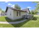 Exterior view of home with a small deck and walkway with a well-maintained yard at 310 W Jackson St, Alexandria, IN 46001
