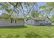 Exterior home view with a nice lawn and mature trees surrounding the property at 310 W Jackson St, Alexandria, IN 46001