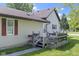 Cozy home featuring a small wooden deck, a well-maintained lawn, and vinyl siding at 310 W Jackson St, Alexandria, IN 46001