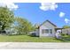 Quaint single-story home with a large lawn, tree, and traditional siding at 310 W Jackson St, Alexandria, IN 46001