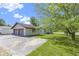 A detached two-car garage featuring a concrete driveway and well-manicured lawn at 310 W Jackson St, Alexandria, IN 46001