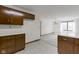 Bright kitchen with wood cabinets, tile flooring, and an open view to the living area at 310 W Jackson St, Alexandria, IN 46001