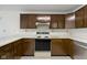Kitchen with wooden cabinets, sleek appliances, and an efficient layout for cooking convenience at 310 W Jackson St, Alexandria, IN 46001