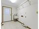 Laundry room featuring tile floor, washer hook ups, and access to outside at 310 W Jackson St, Alexandria, IN 46001