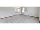 Open living space with carpet flooring, white walls, and easy access to the outdoors at 310 W Jackson St, Alexandria, IN 46001