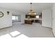 Bright living room with neutral carpet that leads into the open kitchen at 310 W Jackson St, Alexandria, IN 46001