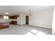 Living room with an open layout featuring wood cabinets and carpet flooring at 310 W Jackson St, Alexandria, IN 46001