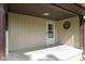 Covered porch area with white front door, vinyl siding, and unique octagon window at 310 W Jackson St, Alexandria, IN 46001
