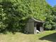Backyard shed for storage with a side ladder and surrounded by greenery at 3587 Lower Patton Park Rd, Martinsville, IN 46151