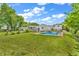 Expansive backyard featuring an in-ground pool with lush greenery offering the ultimate summer oasis at 3624 Woodcliff Dr, Indianapolis, IN 46203
