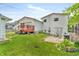Spacious backyard with a red deck, a concrete patio, and lush green grass perfect for outdoor activities at 3624 Woodcliff Dr, Indianapolis, IN 46203