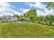 Large backyard with an in-ground pool, mature trees, and a shed offering an ideal space for recreation at 3624 Woodcliff Dr, Indianapolis, IN 46203