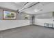 Spacious basement featuring two windows, neutral carpet, and white-painted walls at 3624 Woodcliff Dr, Indianapolis, IN 46203