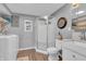 Bathroom with a tile floor, a walk-in shower, toilet, and washer at 3624 Woodcliff Dr, Indianapolis, IN 46203