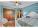 Comfortable bedroom with a ceiling fan, wooden closet, and stylish white furniture at 3624 Woodcliff Dr, Indianapolis, IN 46203