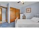 Comfortable bedroom with a ceiling fan, wooden closet, and stylish white furniture at 3624 Woodcliff Dr, Indianapolis, IN 46203