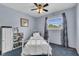 Comfortable bedroom with a ceiling fan, window, and white furniture at 3624 Woodcliff Dr, Indianapolis, IN 46203