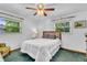 Bedroom with carpeted floors, ceiling fan, neutral walls, and natural lighting at 3624 Woodcliff Dr, Indianapolis, IN 46203